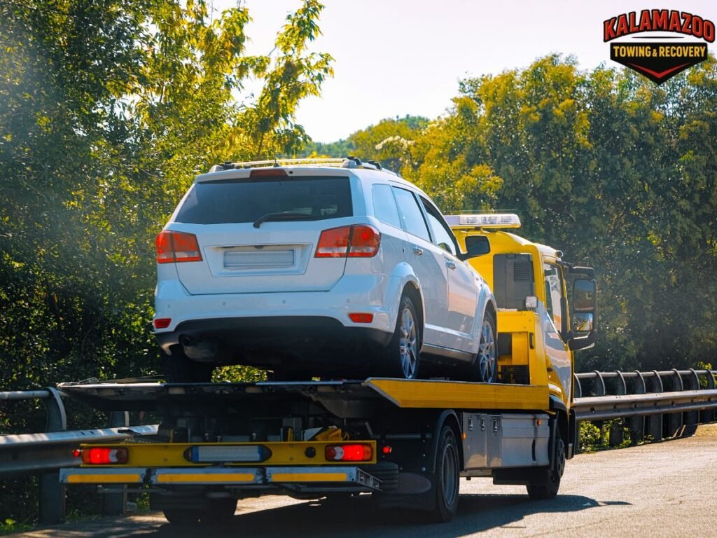 Towed vehicle in impound lot with Kalamazoo towing notice on windshield